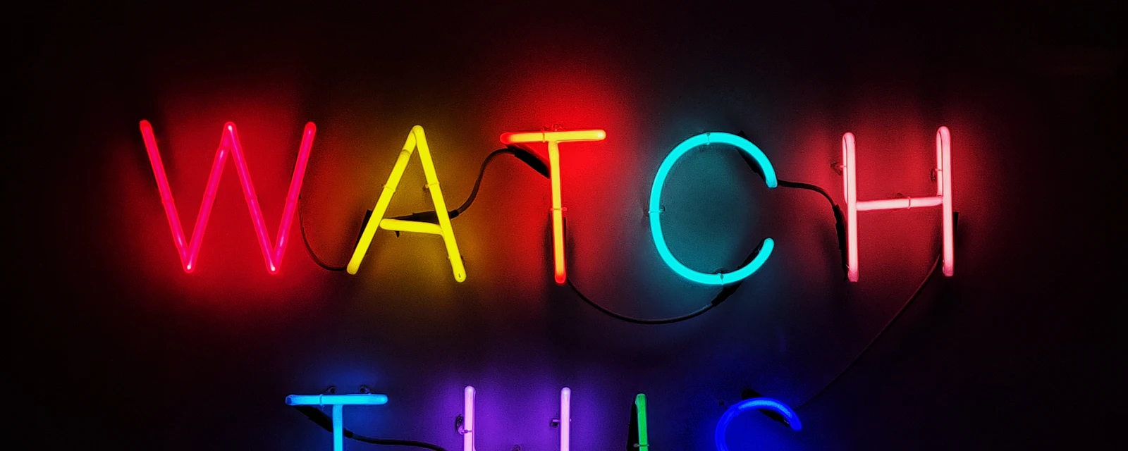 A neon sign that reads Watch This Space